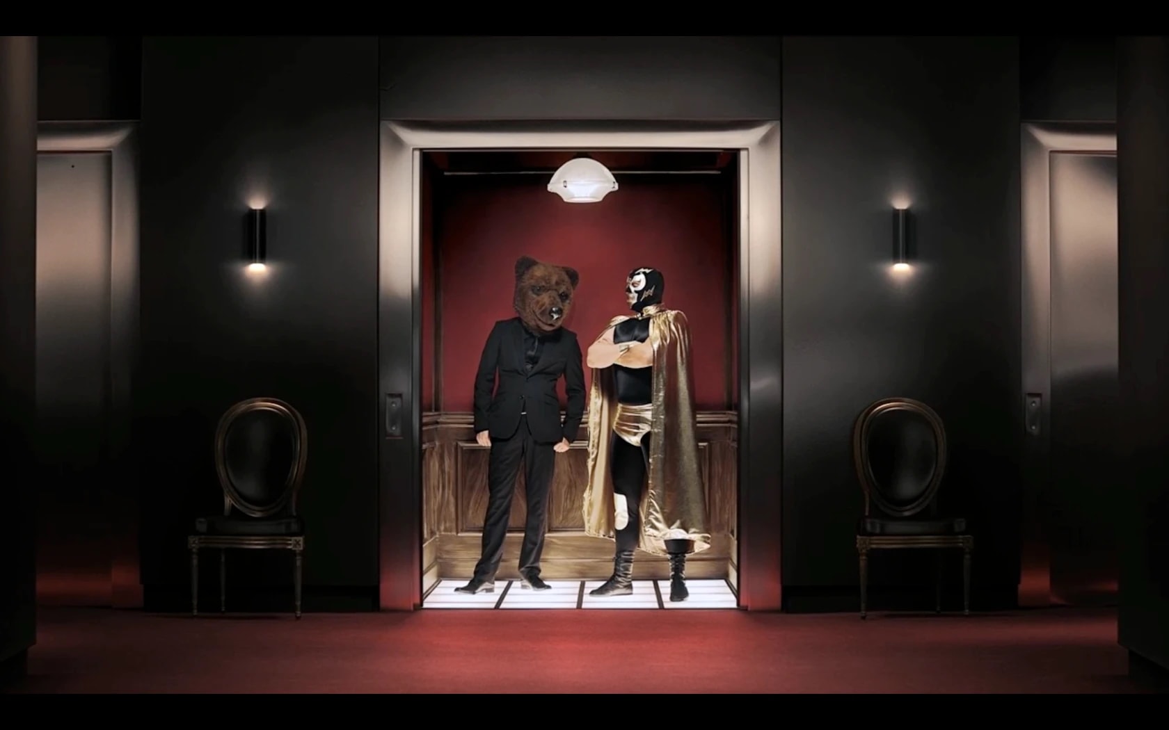 Bear and masked superhero standing in an elevator